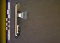 ADLO - Security door JUBEO, door surface Woodline Mocca in horizontal, security fitting Brit